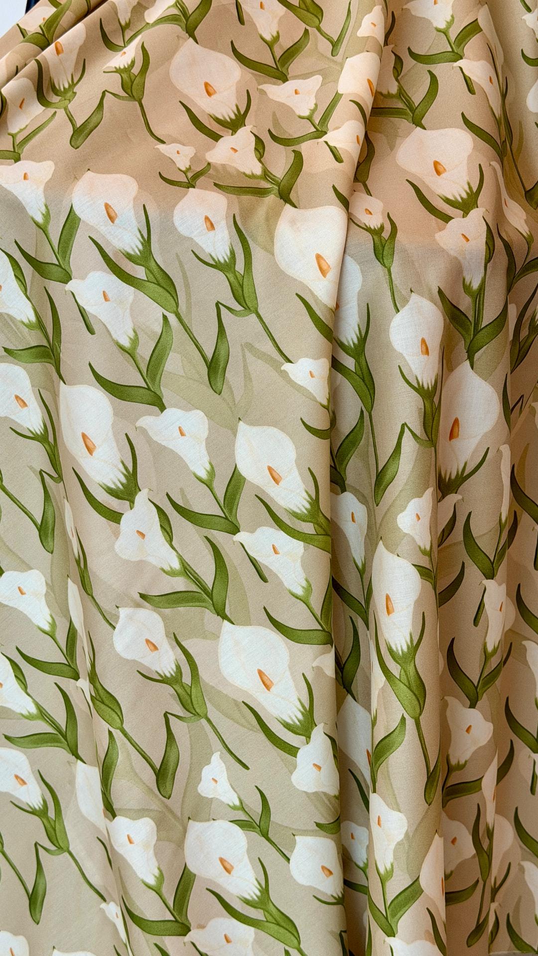 MWARRAD fabric with white flowers and green stems in soft folds